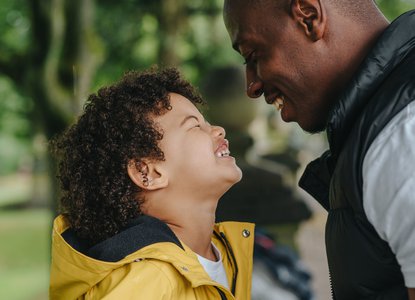 Dad and boy outside looking at each other