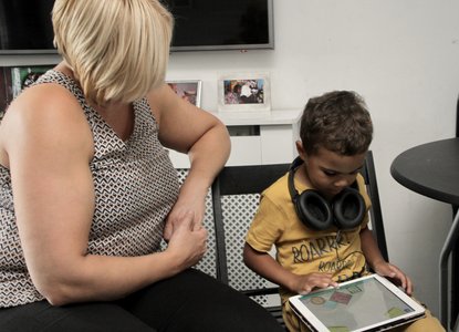 Child, parent and iPad