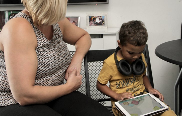 Child, parent and iPad