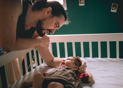 dad putting baby to sleep