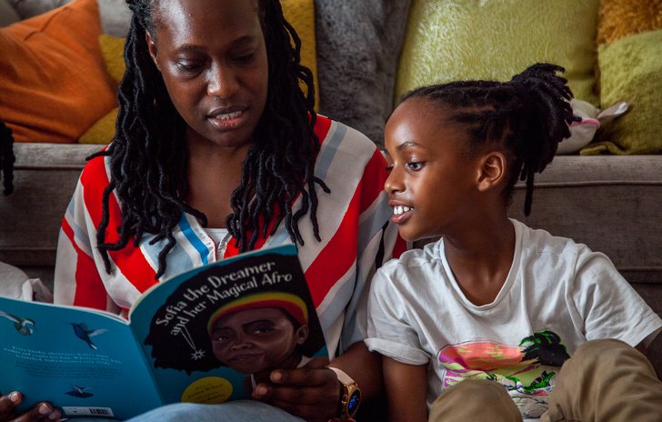 Boy reading with his parent
