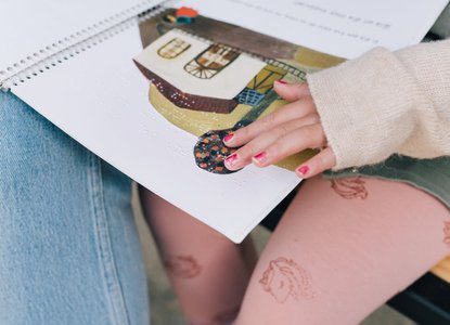 child reading braille