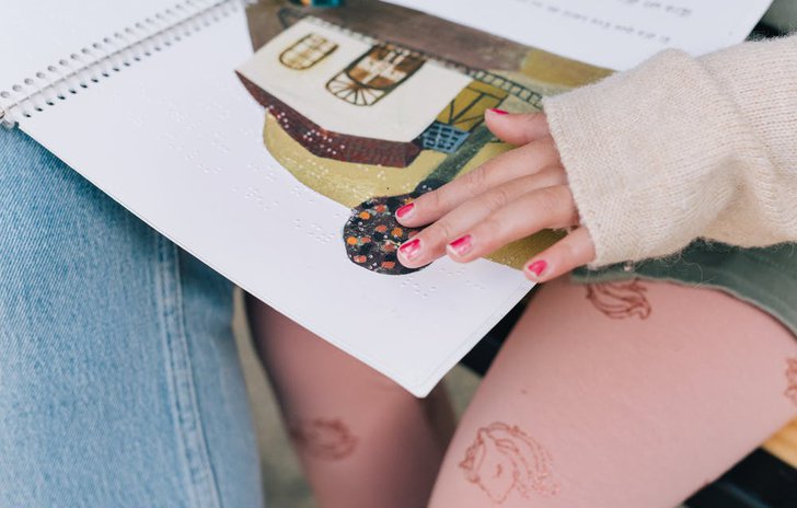 child reading braille