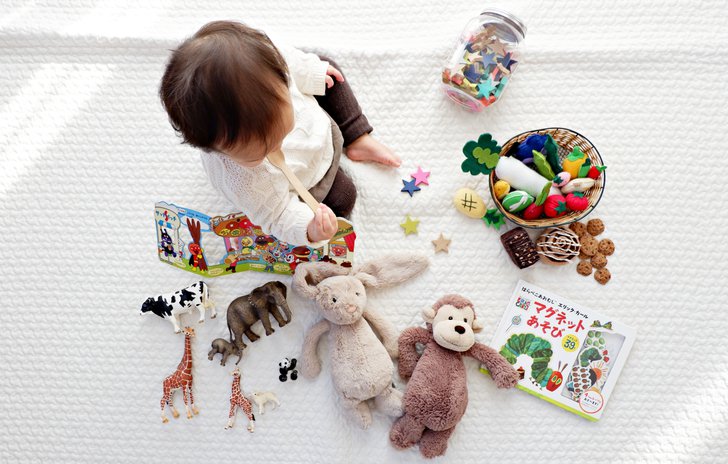 One year old playing with toys on the floor